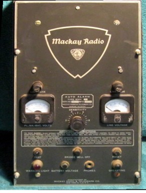 Small unit witlh large Mackay Radio symbol, 2 meters,  2 fuse holders,  2 pilot lights and a sensitivity control knob.